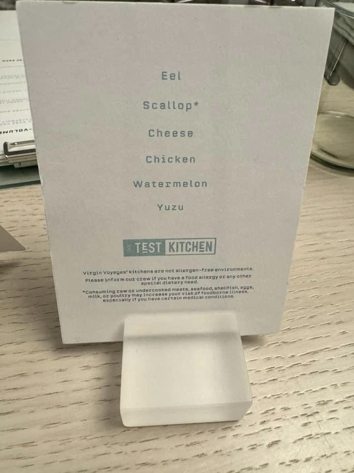 Menu card listing: Eel, Scallop, Cheese, Chicken, Watermelon, Yuzu. Below is a note about allergen awareness and the Test Kitchen logo.