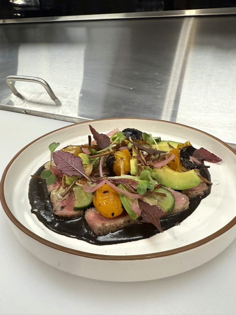 Charcoal seared ribeye, pickled onions, avocado, recado negro, blistered tomatoes, chile toreado